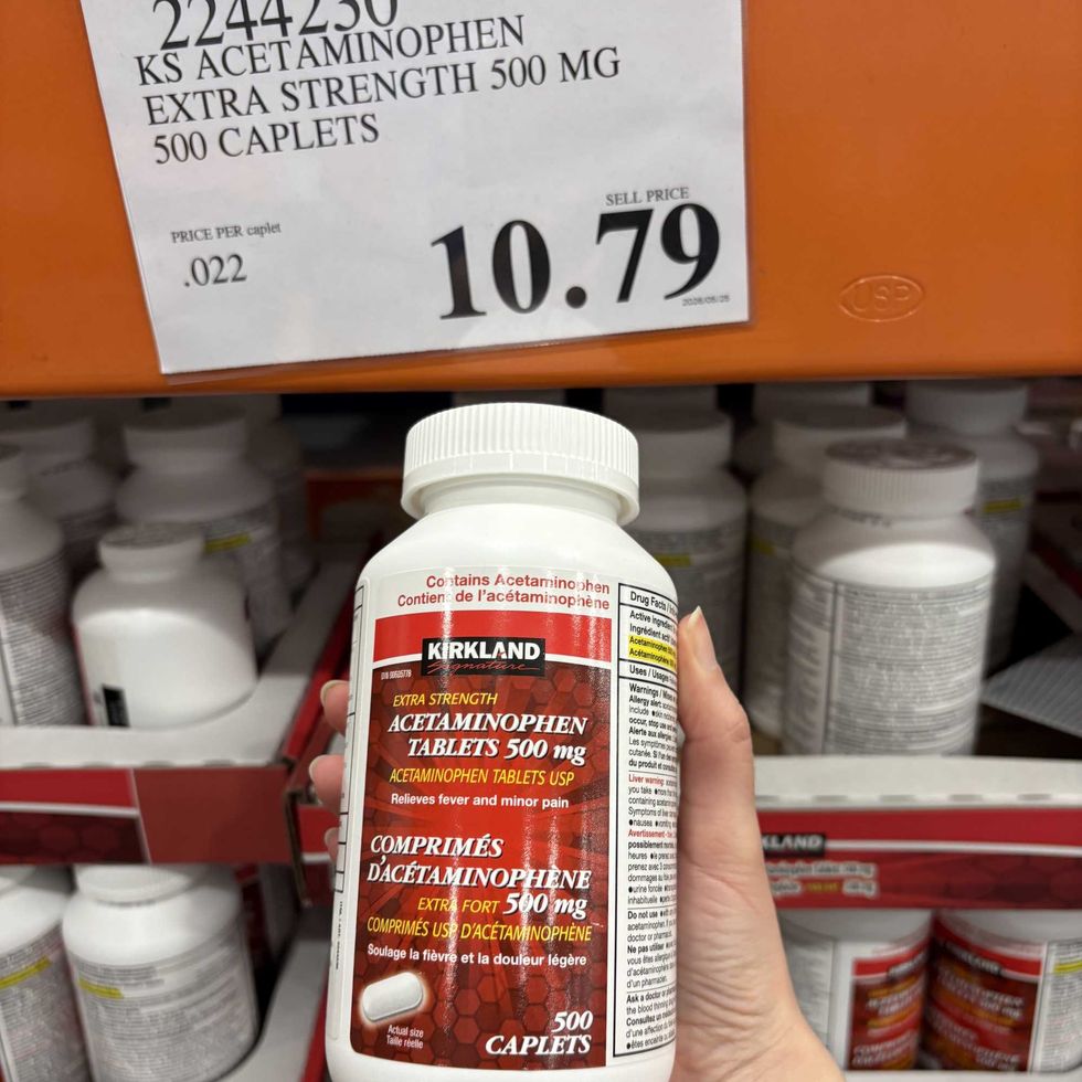 person holding bottle of Kirkland Signature extra-strength acetaminophen at Costco