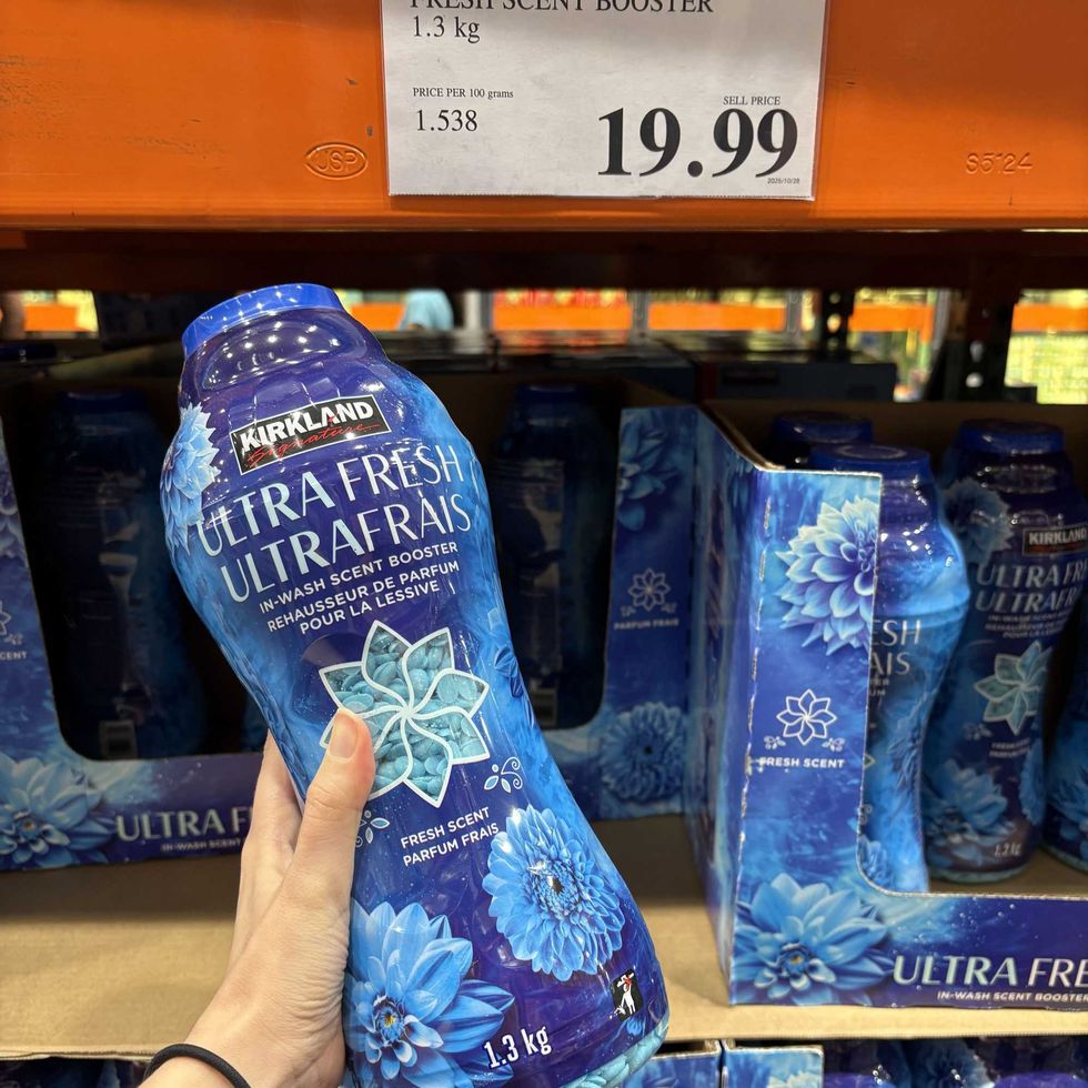 person holding bottle of \u200b\u200bKirkland Signature laundry beads at costco