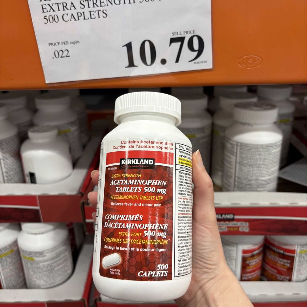 person holding bottle of \u200bKirkland Signature extra-strength acetaminophen at costco