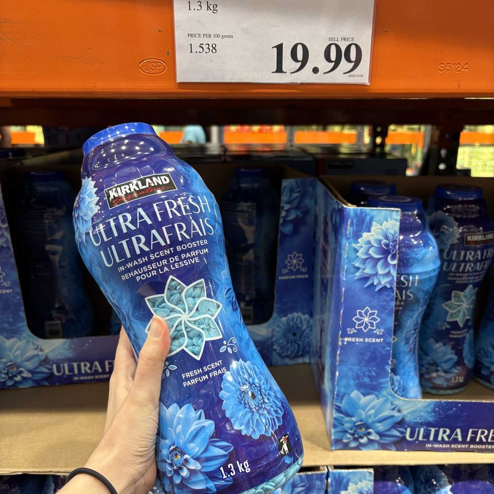 person holding bottle of \u200bKirkland Signature laundry beads at Costco