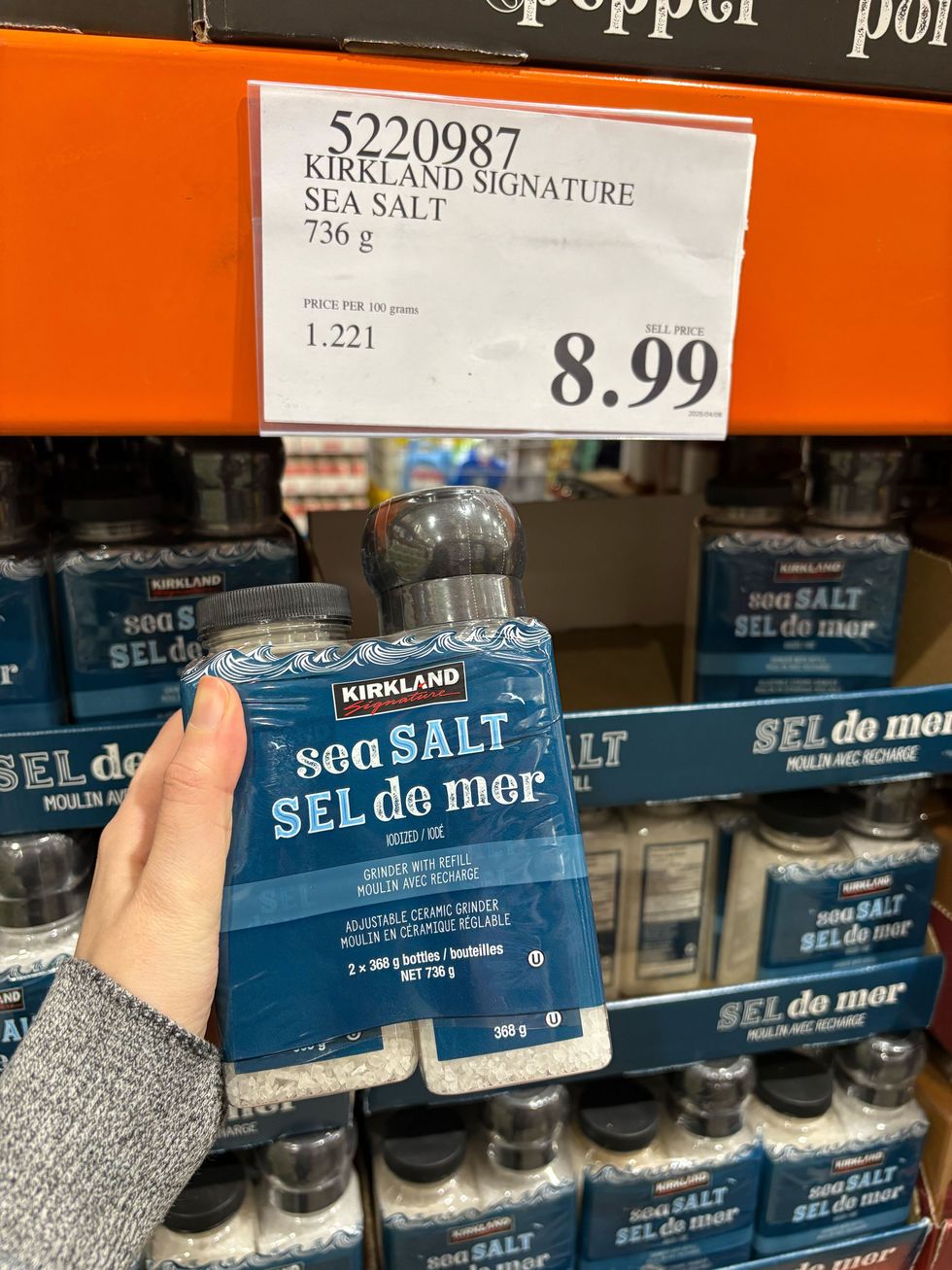 person holding bottles of kirkland signature sea salt