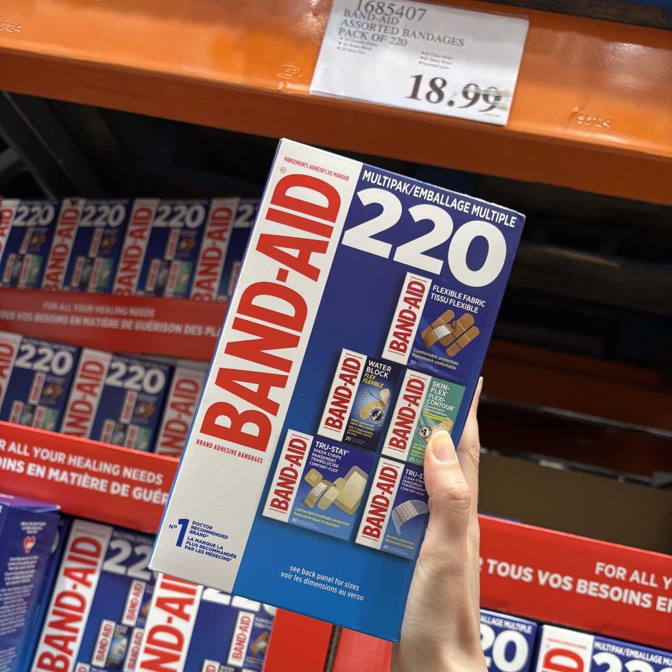 person holding box of Band-Aid bandages at Costco