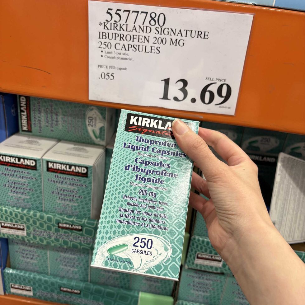 person holding box of Kirkland Signature ibuprofen at Costco