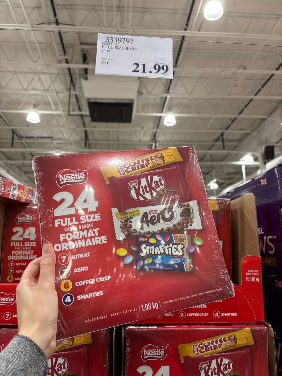 person holding box of nestle chocolates at costco