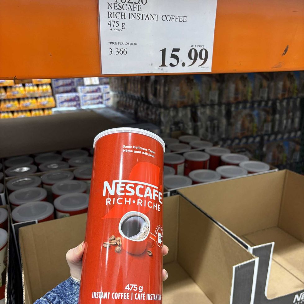 person holding canister of \u200bNescafe instant coffee at Costco