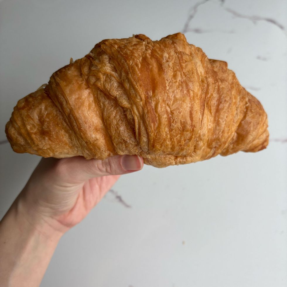 person holding costco croissant