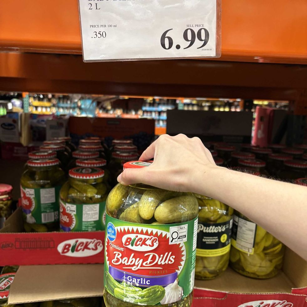 person holding jar of Bick's pickles at Costco