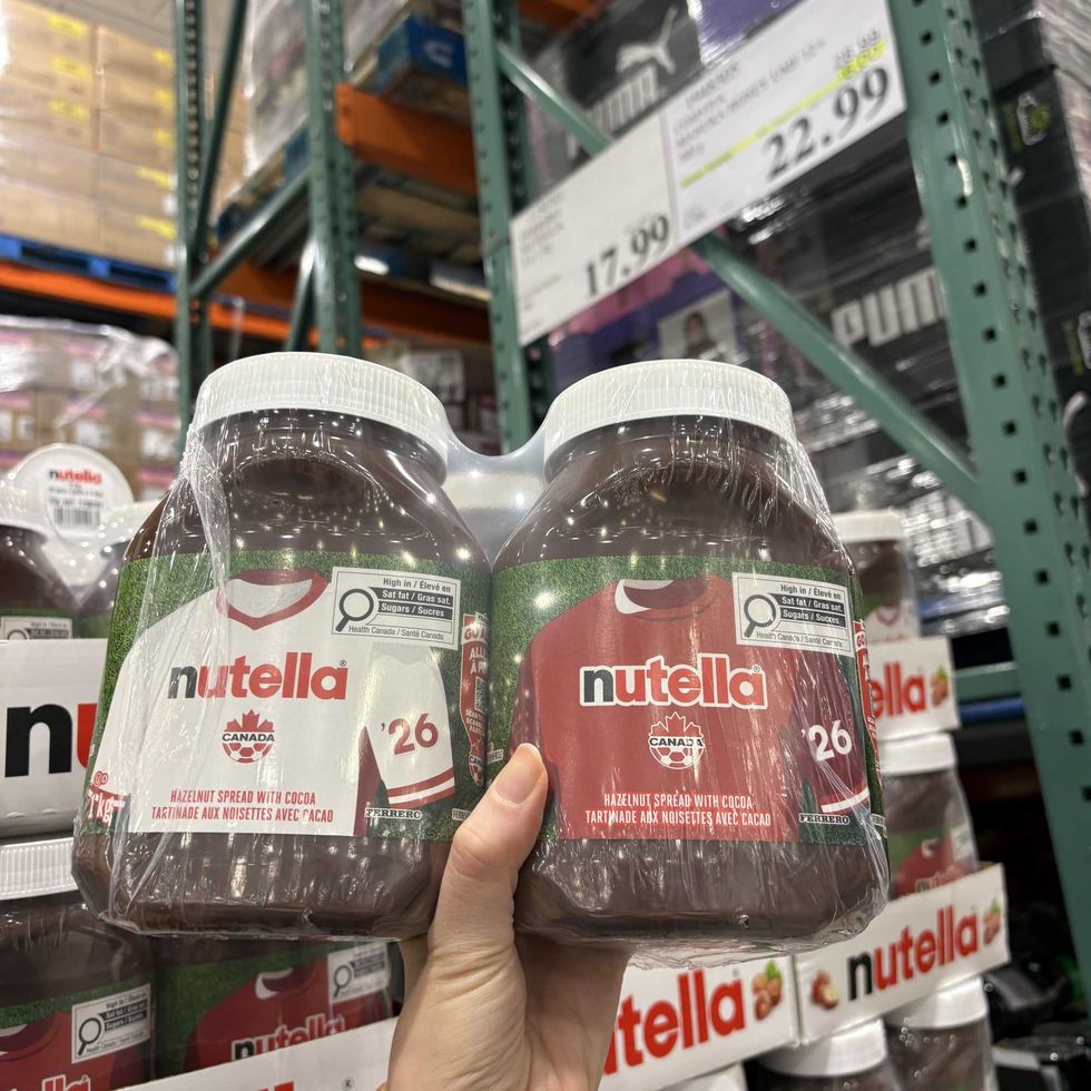 person holding jars of Nutella at costco