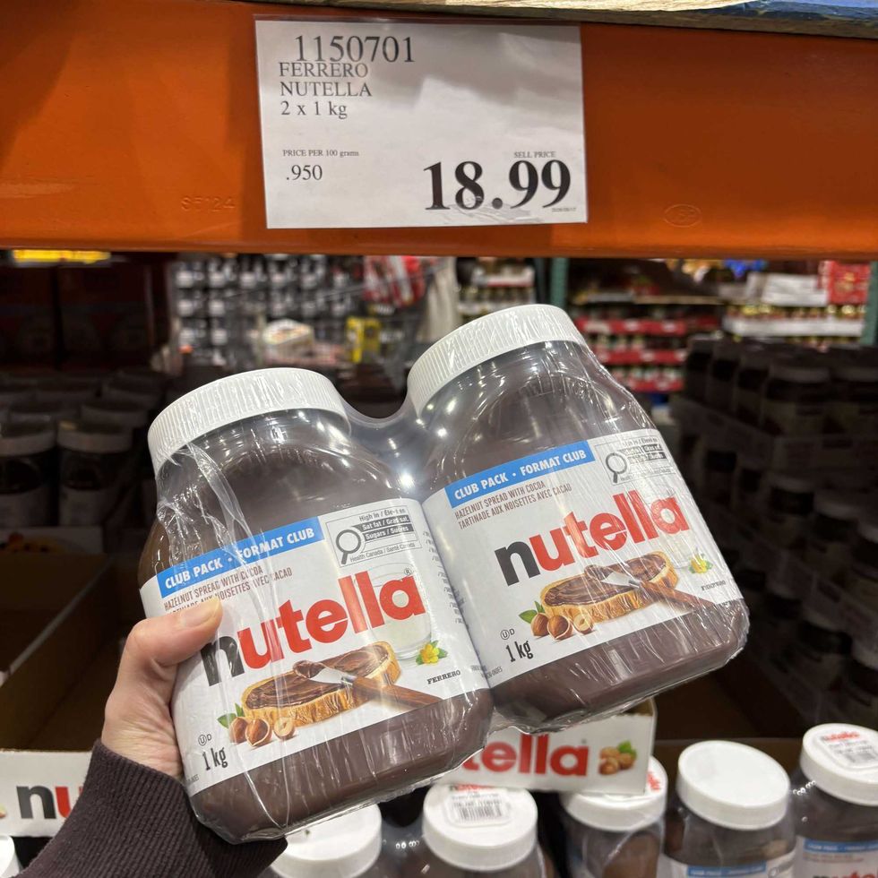person holding jars of Nutella at costco