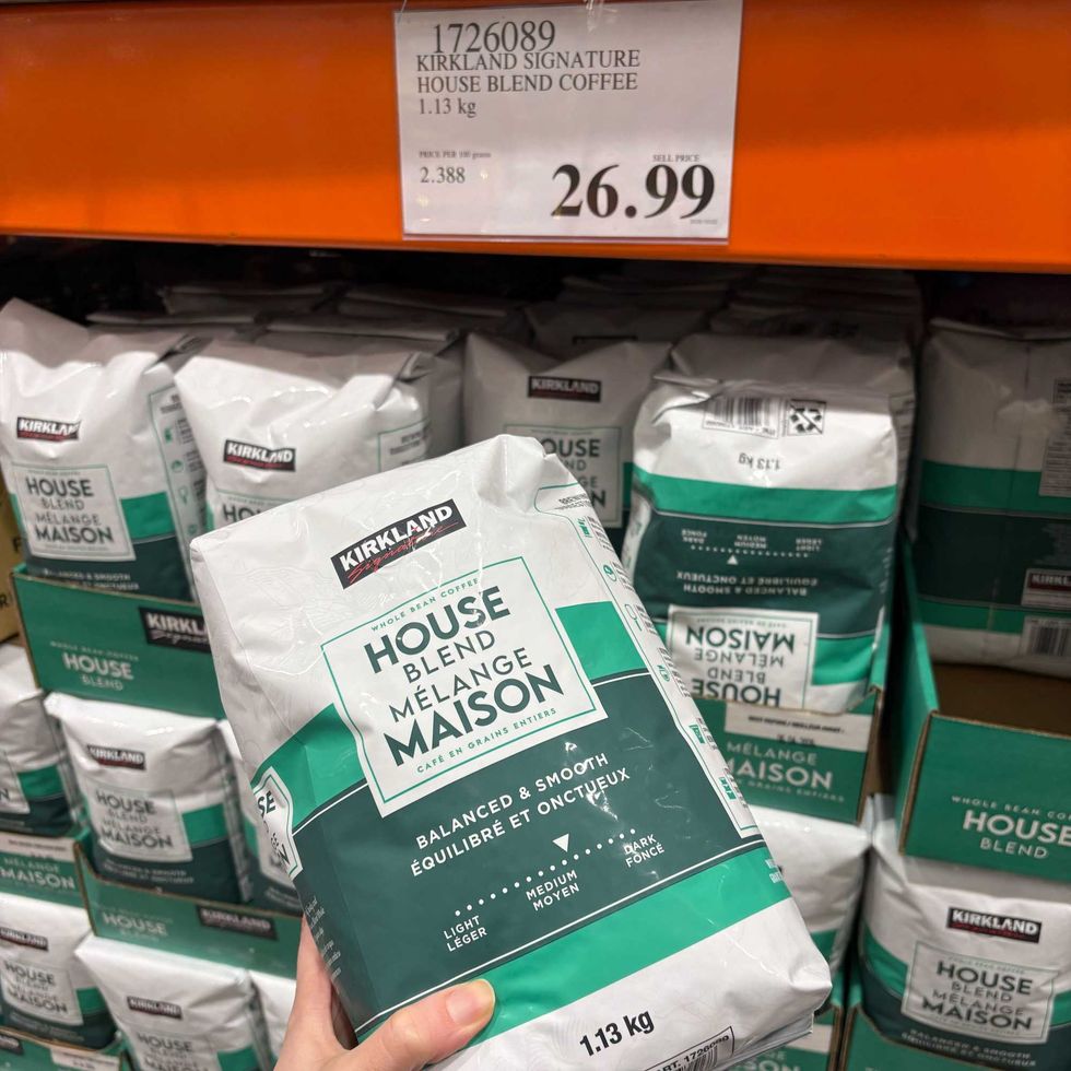 person holding Kirkland Signature house blend coffee