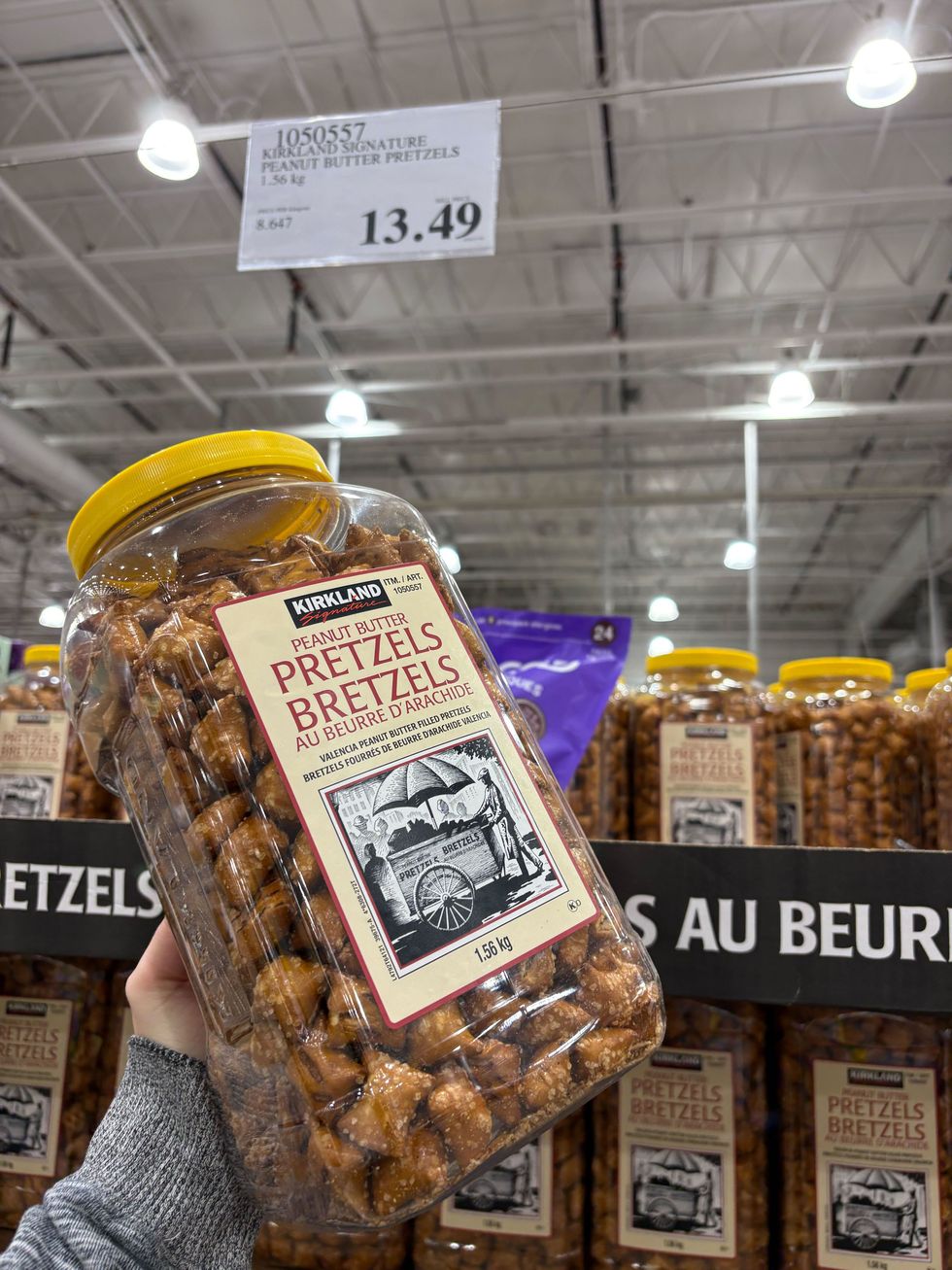 person holding kirkland signature peanut butter pretzels