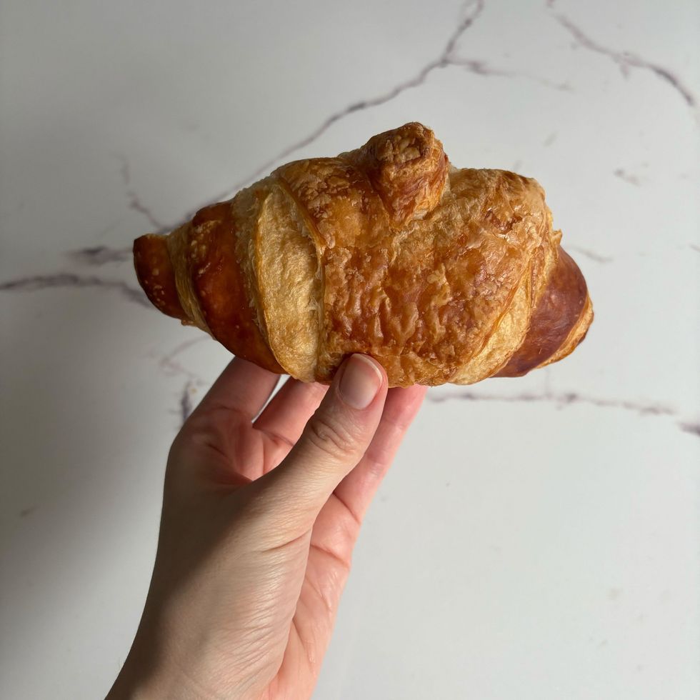 person holding loblaws croissant