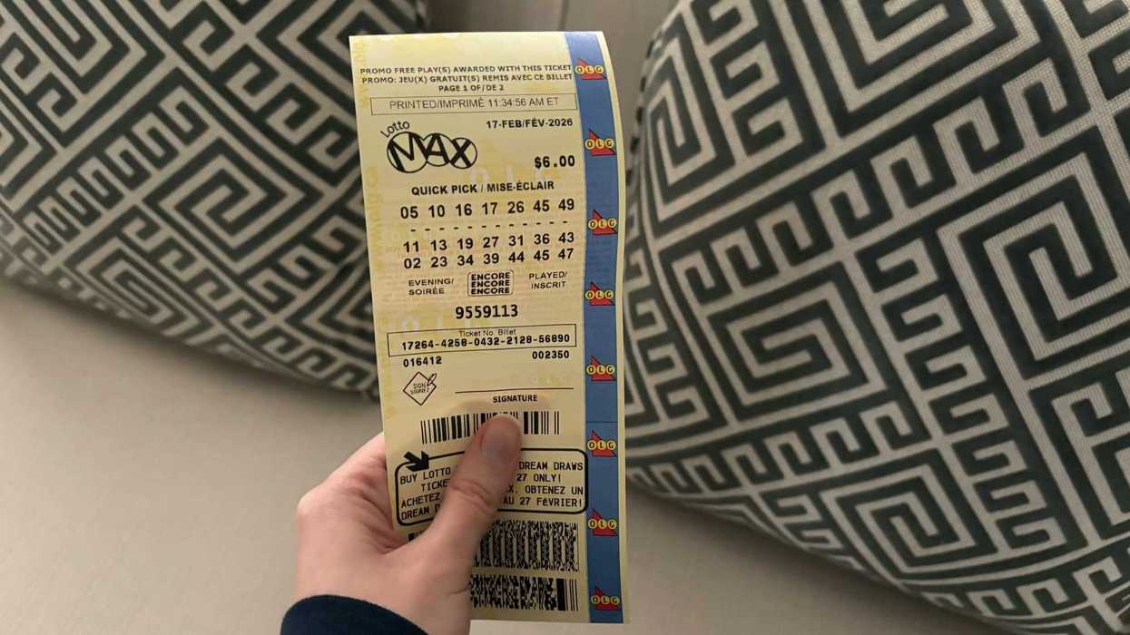 person holding lotto max ticket form olg