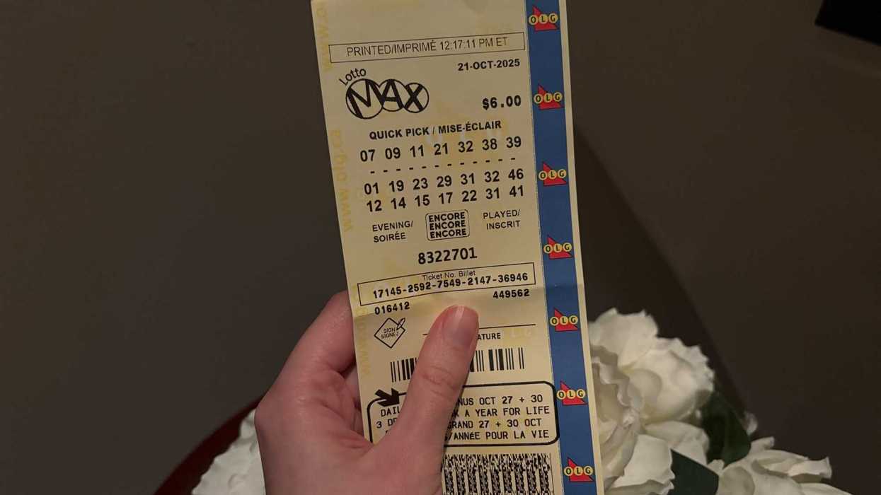 person holding lotto max ticket from olg