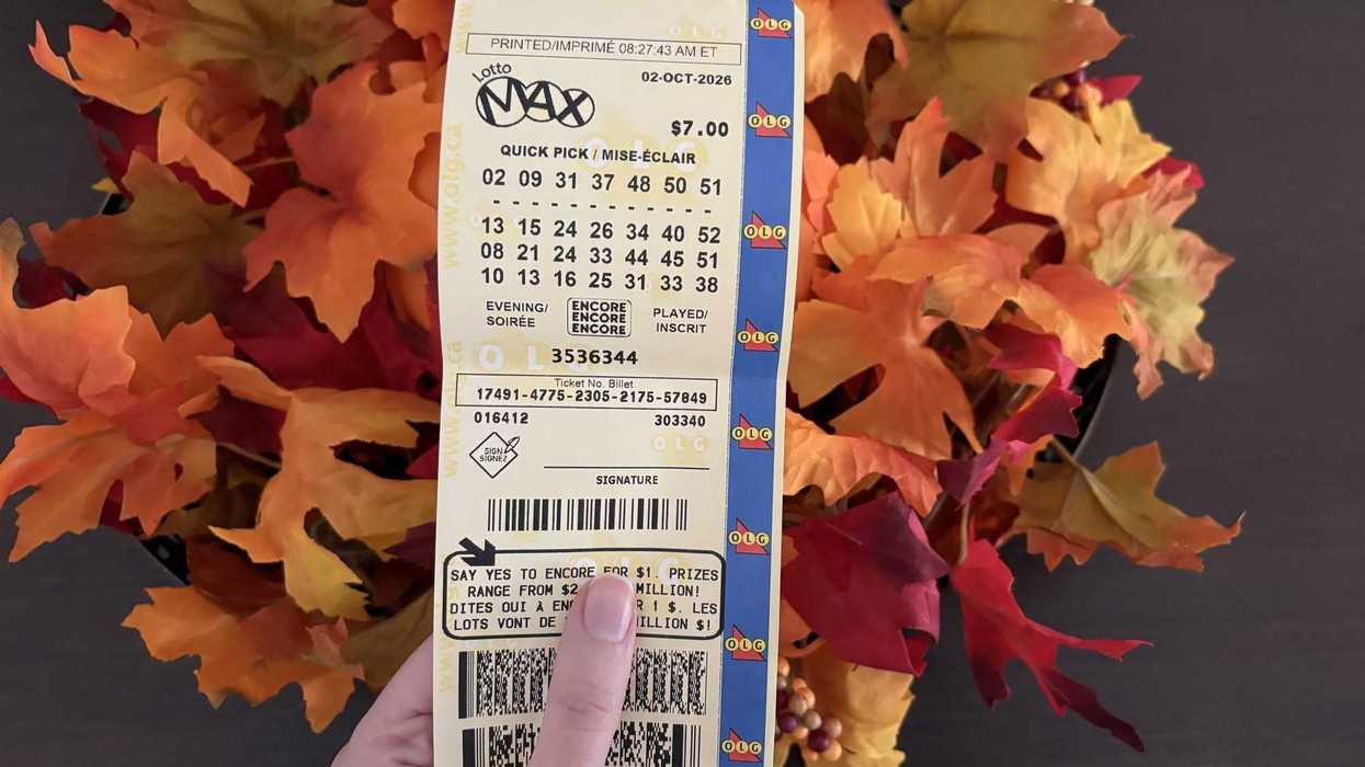 person holding lotto max ticket from olg