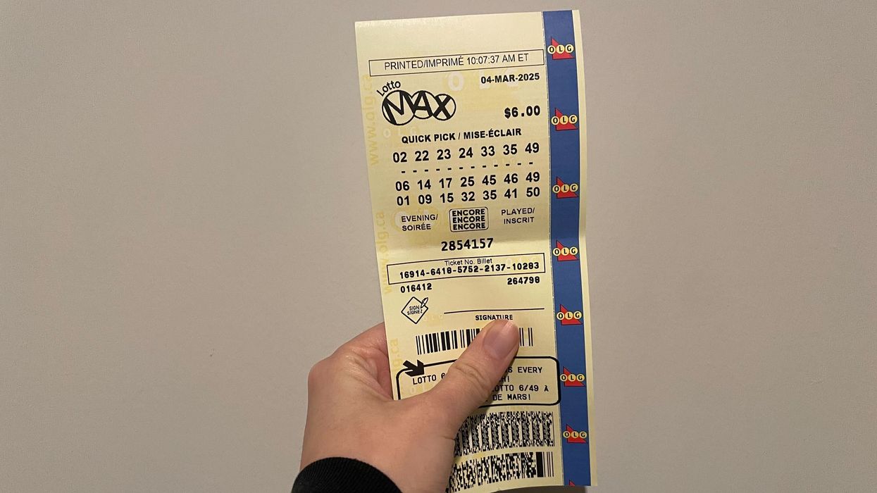 person holding lotto max ticket