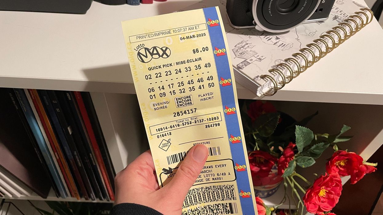 person holding lotto max ticket