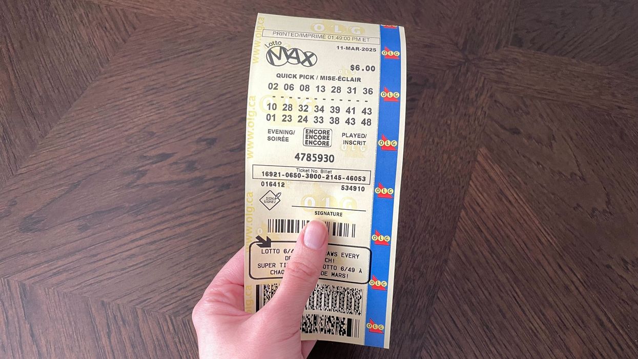 person holding lotto max ticket