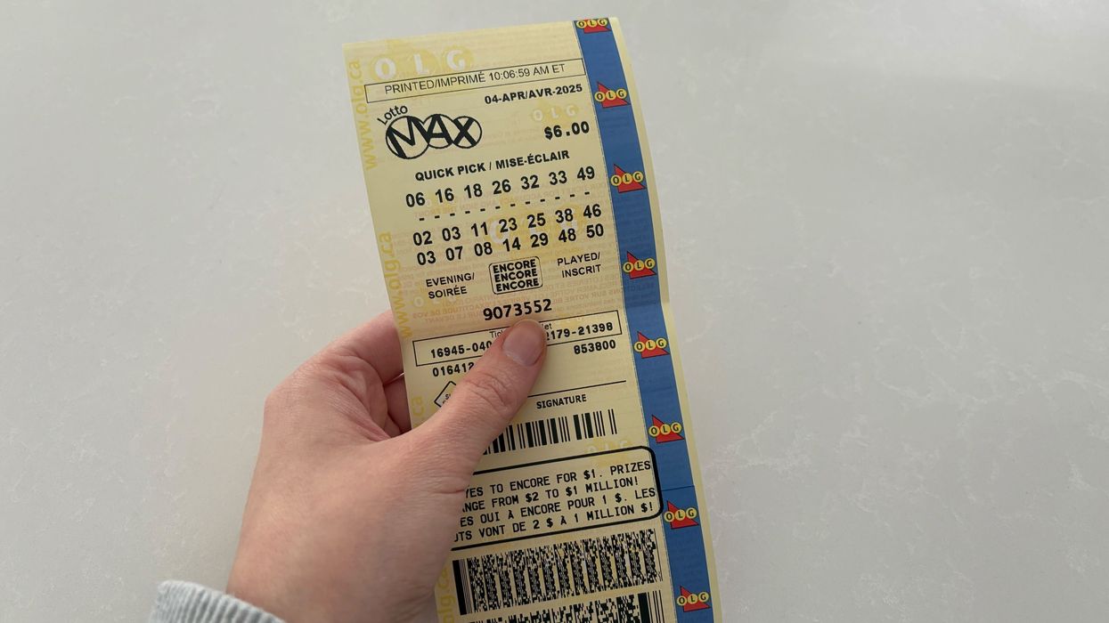 person holding lotto max ticket