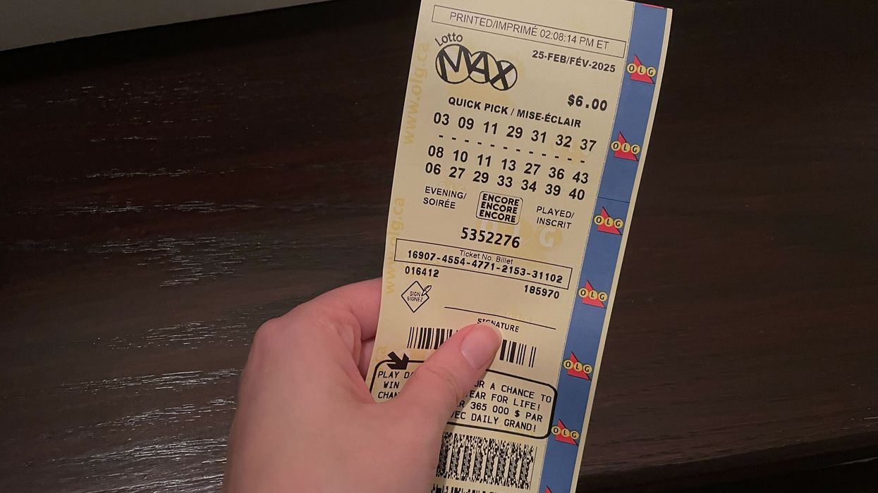 person holding lotto max ticket