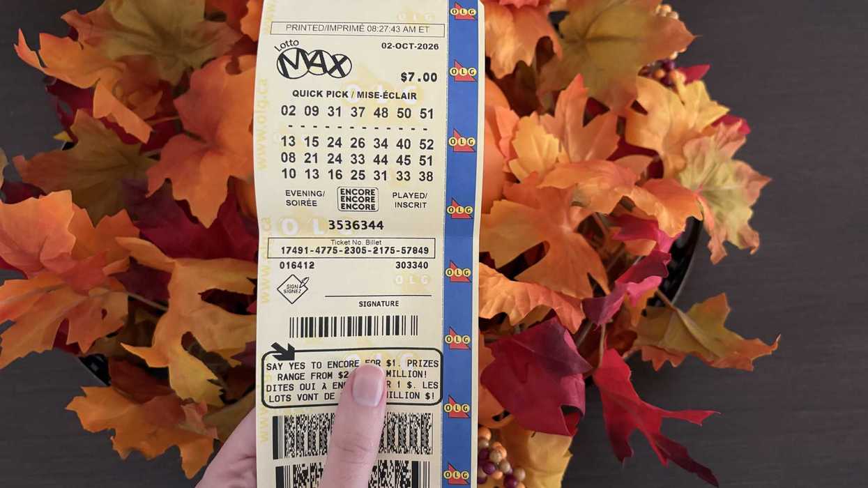 person holding lotto max ticket