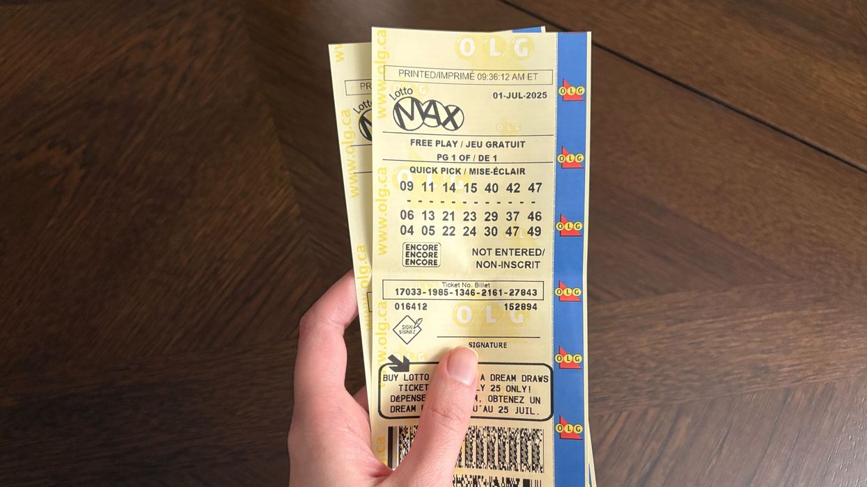 person holding lotto max tickets from olg