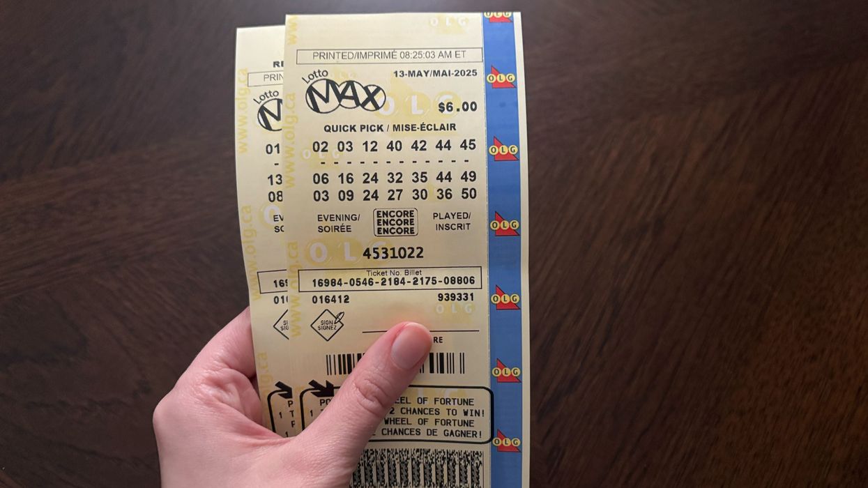 person holding lotto max tickets from olg