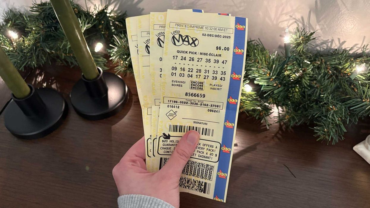 person holding lotto max tickets from olg