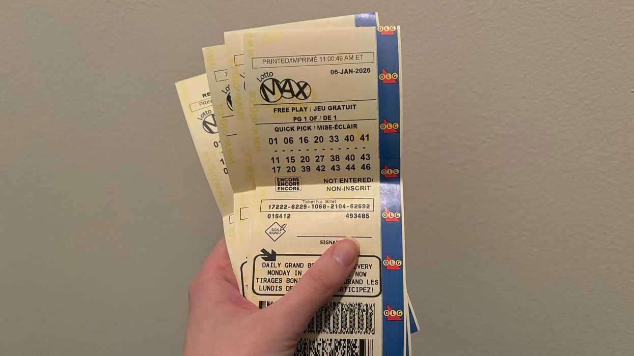 person holding lotto max tickets from olg