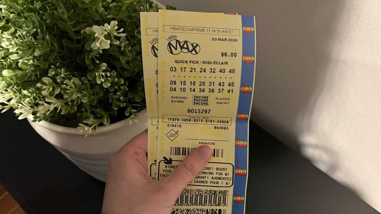 person holding lotto max tickets from olg