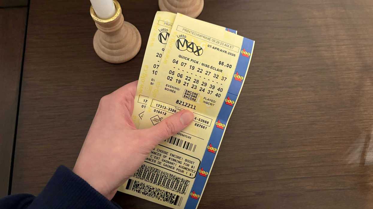 person holding lotto max tickets from olg