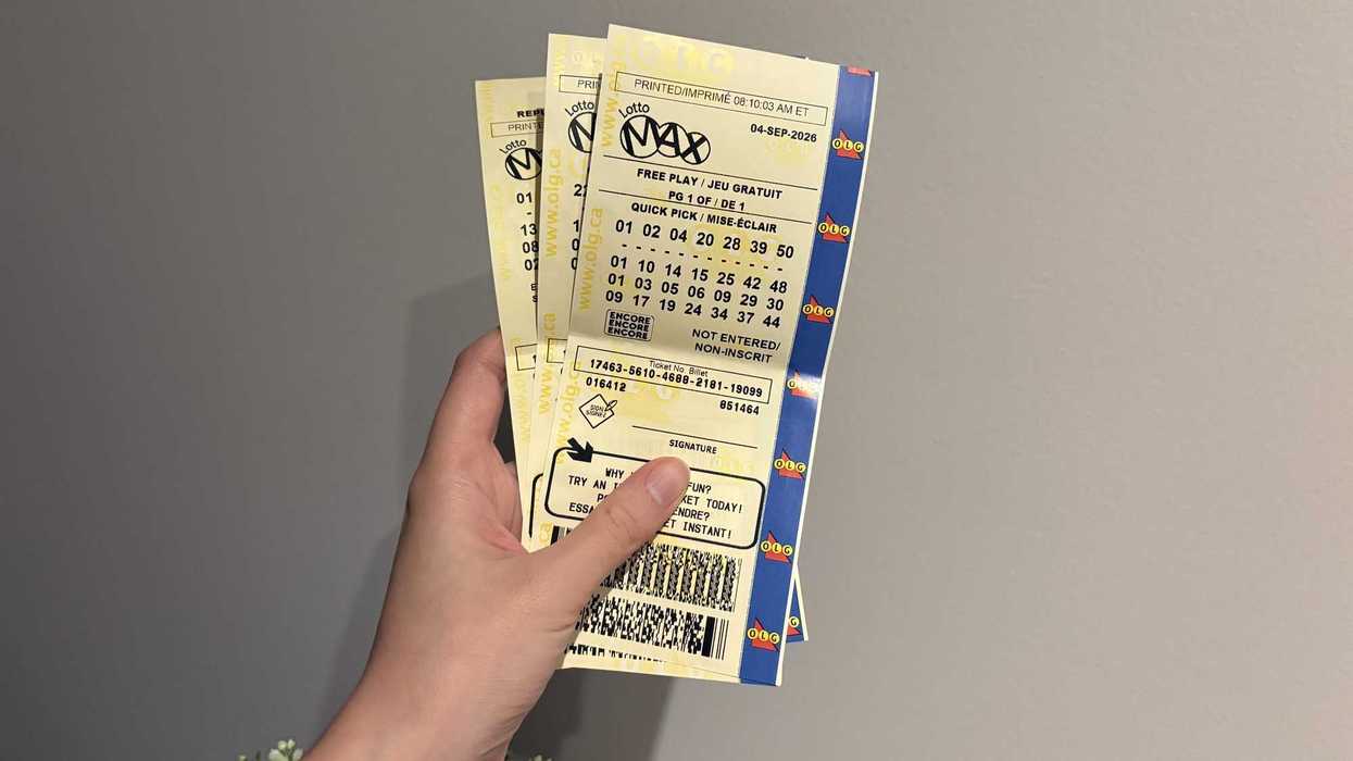 person holding lotto max tickets from olg