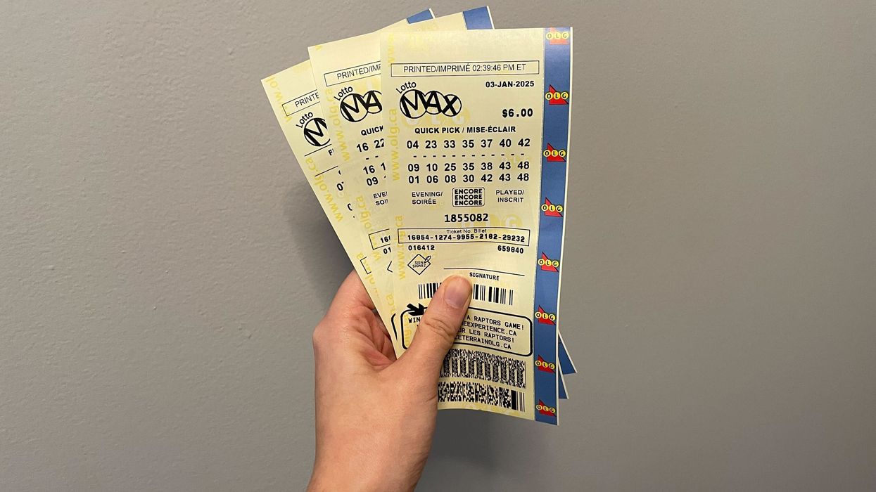 person holding lotto max tickets