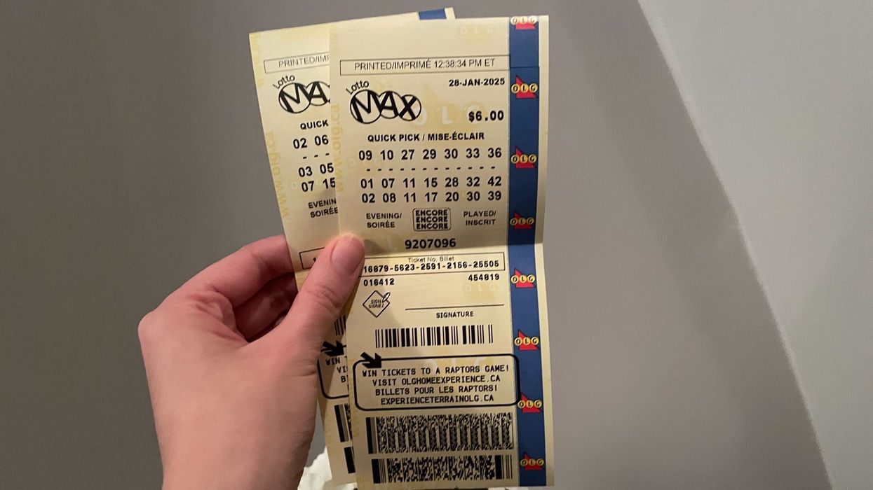person holding lotto max tickets