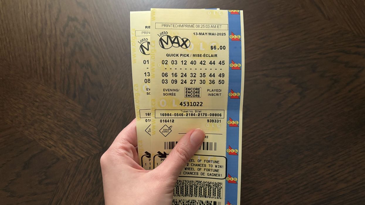person holding lotto max tickets