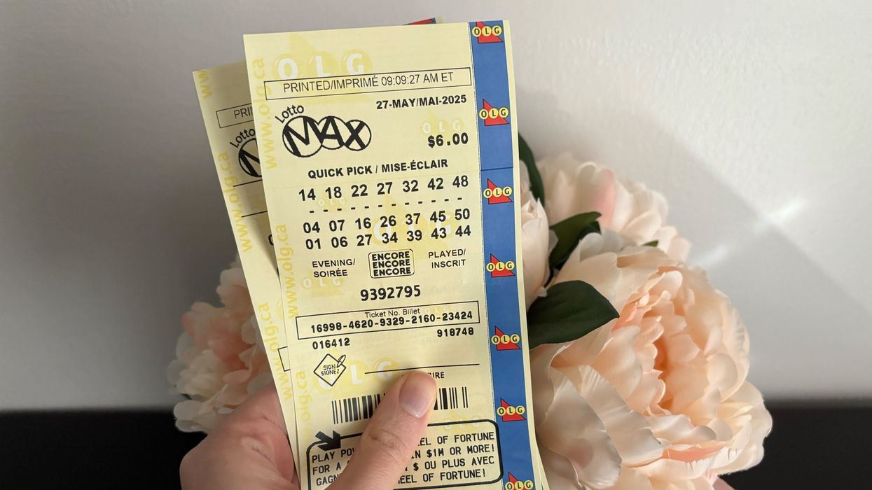 person holding lotto max tickets