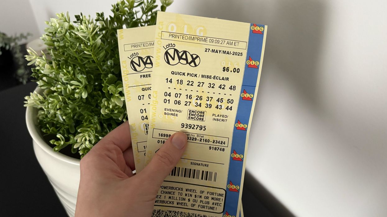 person holding lotto max tickets
