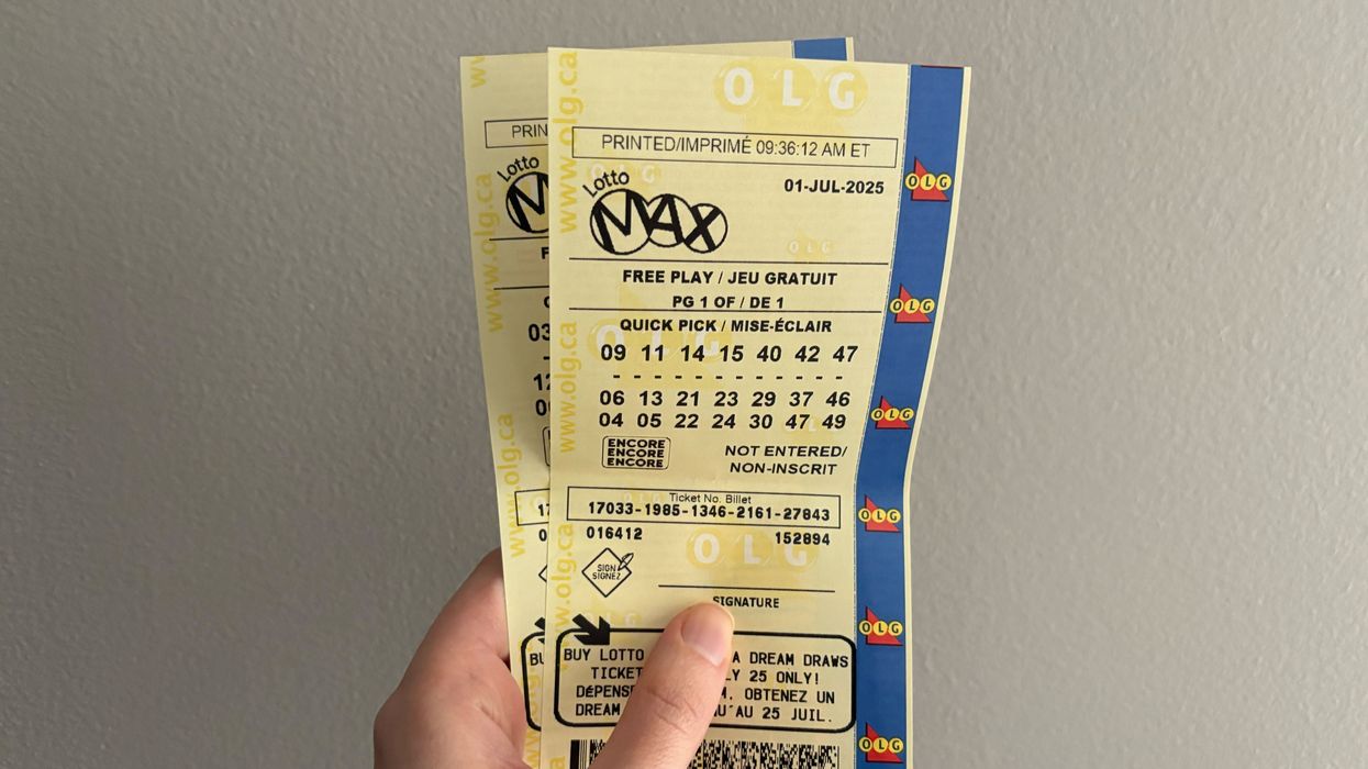 person holding lotto max tickets