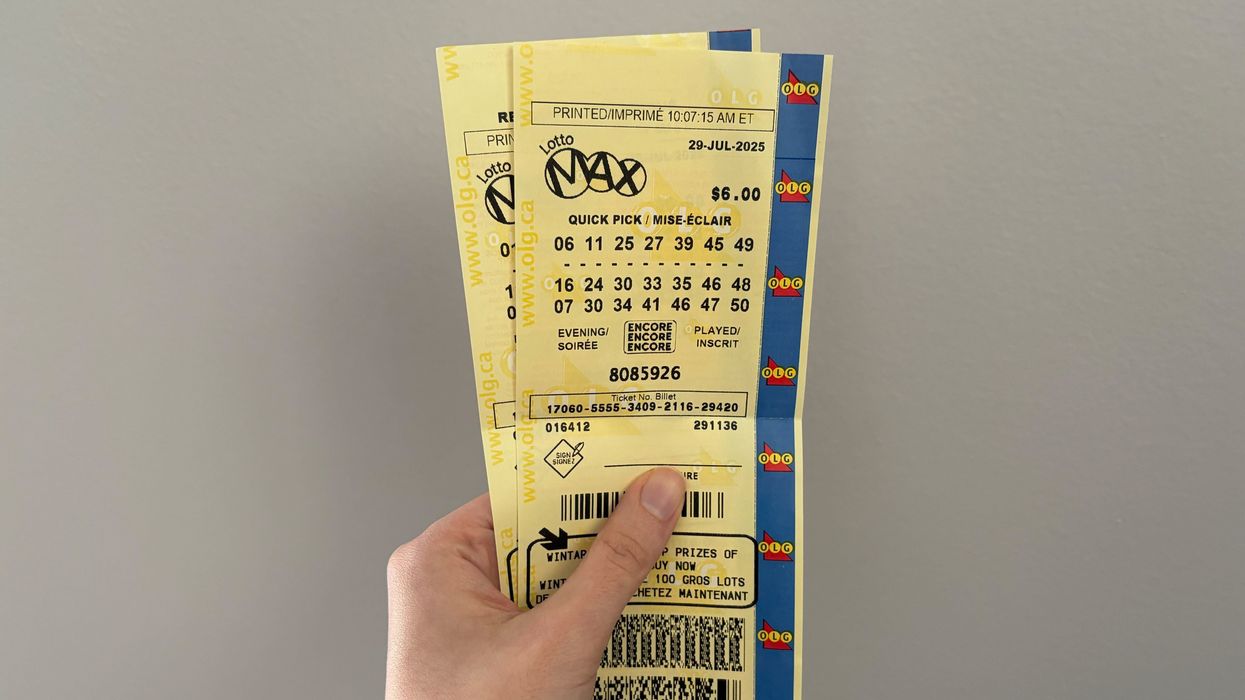 person holding lotto max tickets