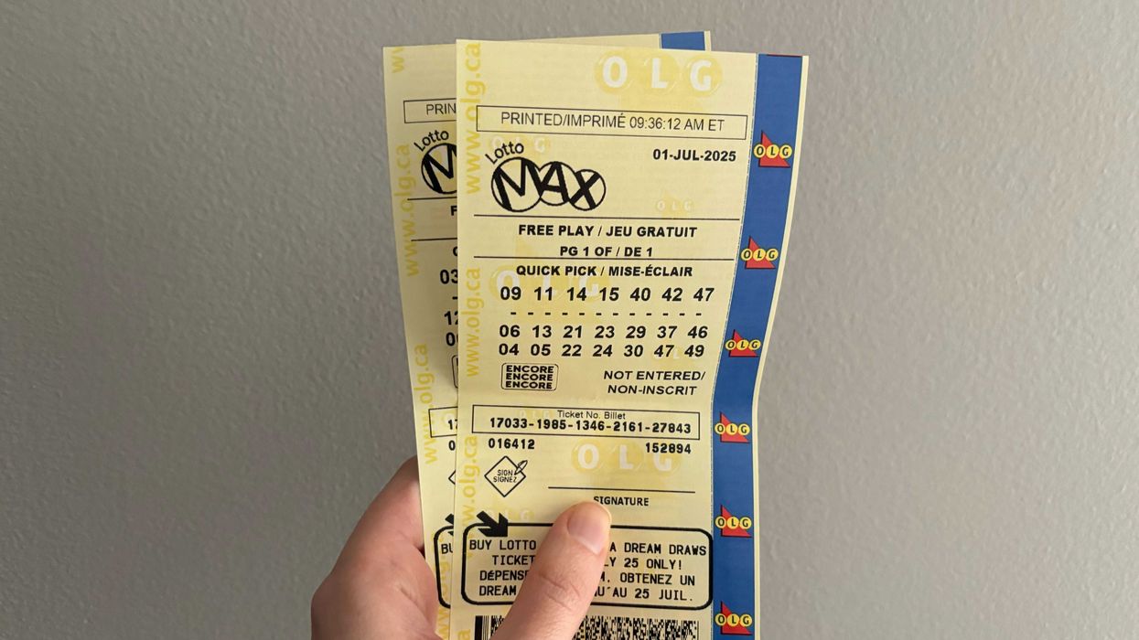 person holding lotto max tickets