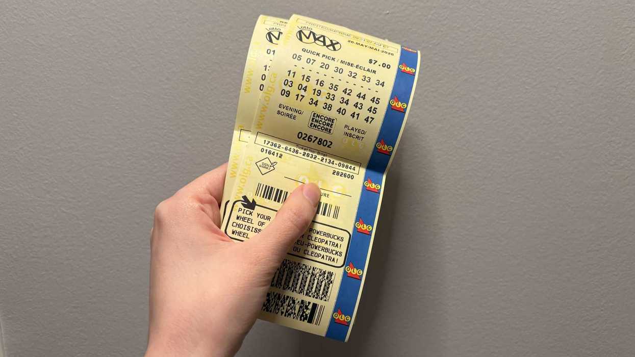 person holding lotto max tickets