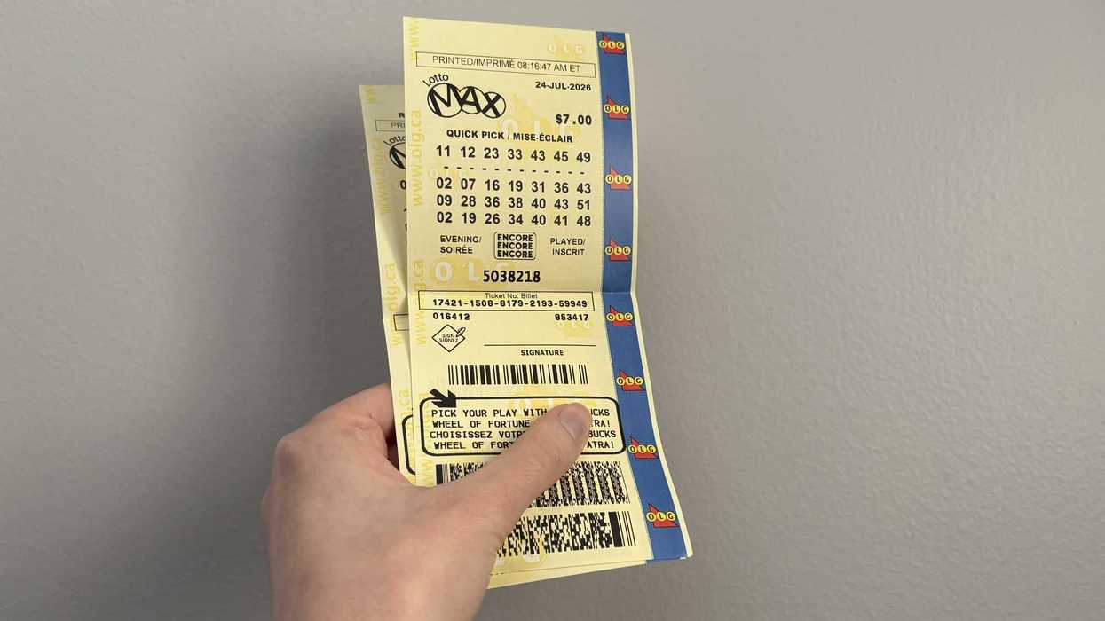 person holding lotto max tickets