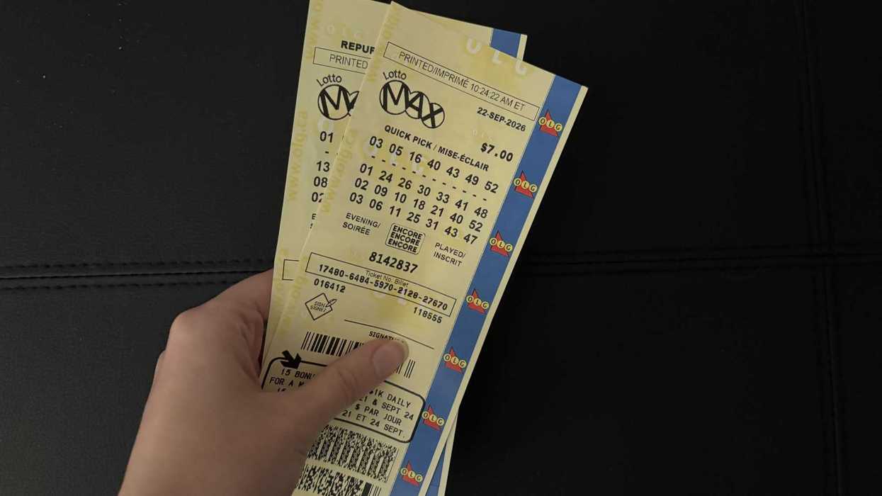 person holding lotto max tickets