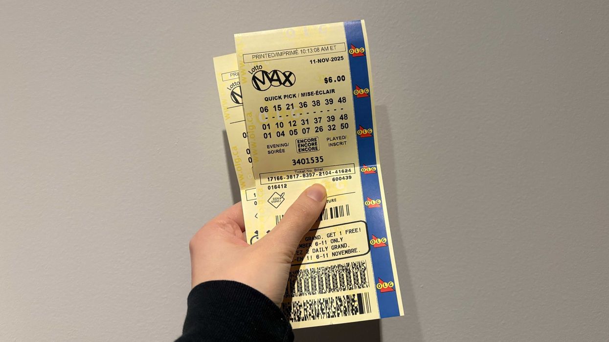 person holding olg lotto max tickets