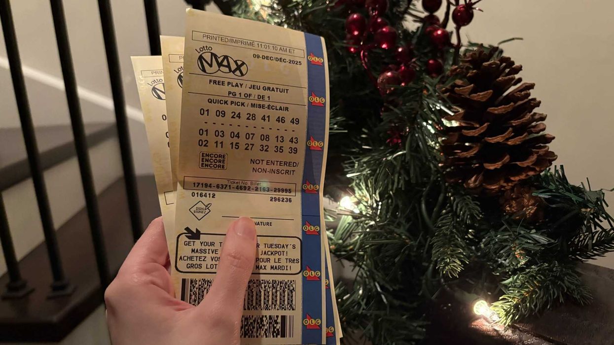 person holding olg lotto max tickets