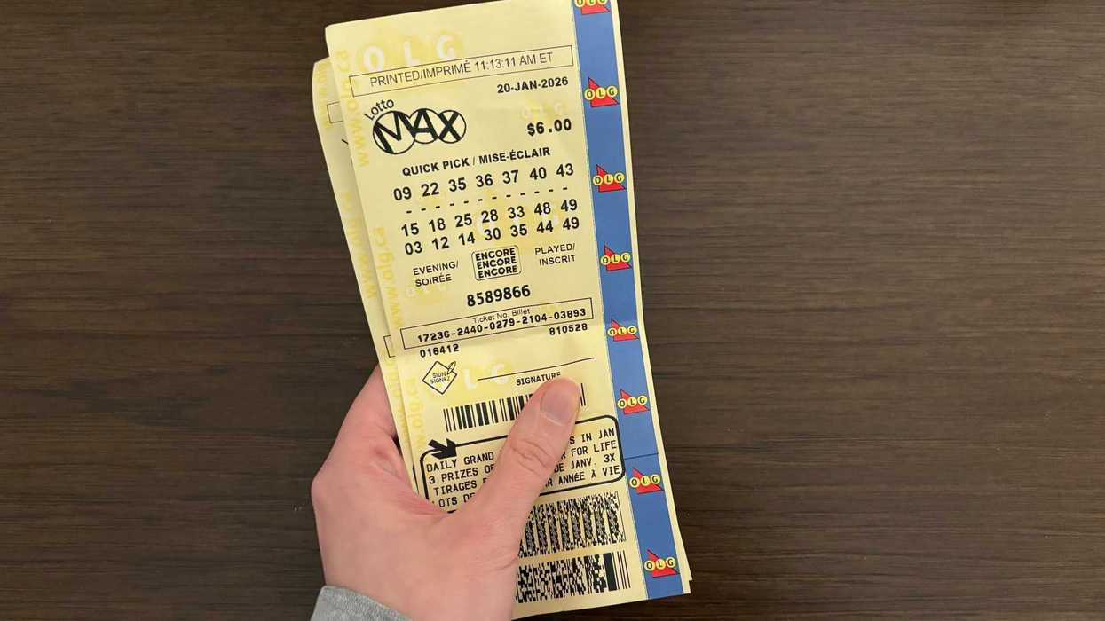person holding olg lotto max tickets