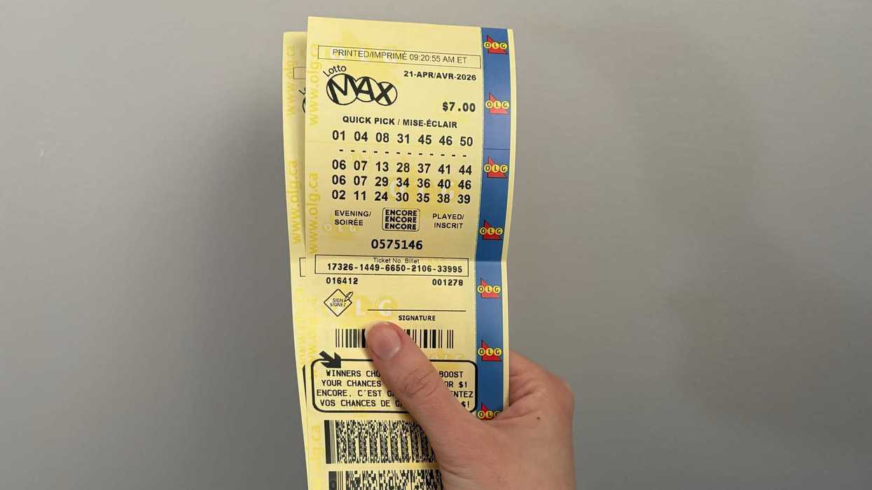 person holding olg lotto max tickets