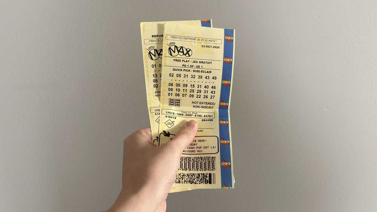 person holding olg lotto max tickets