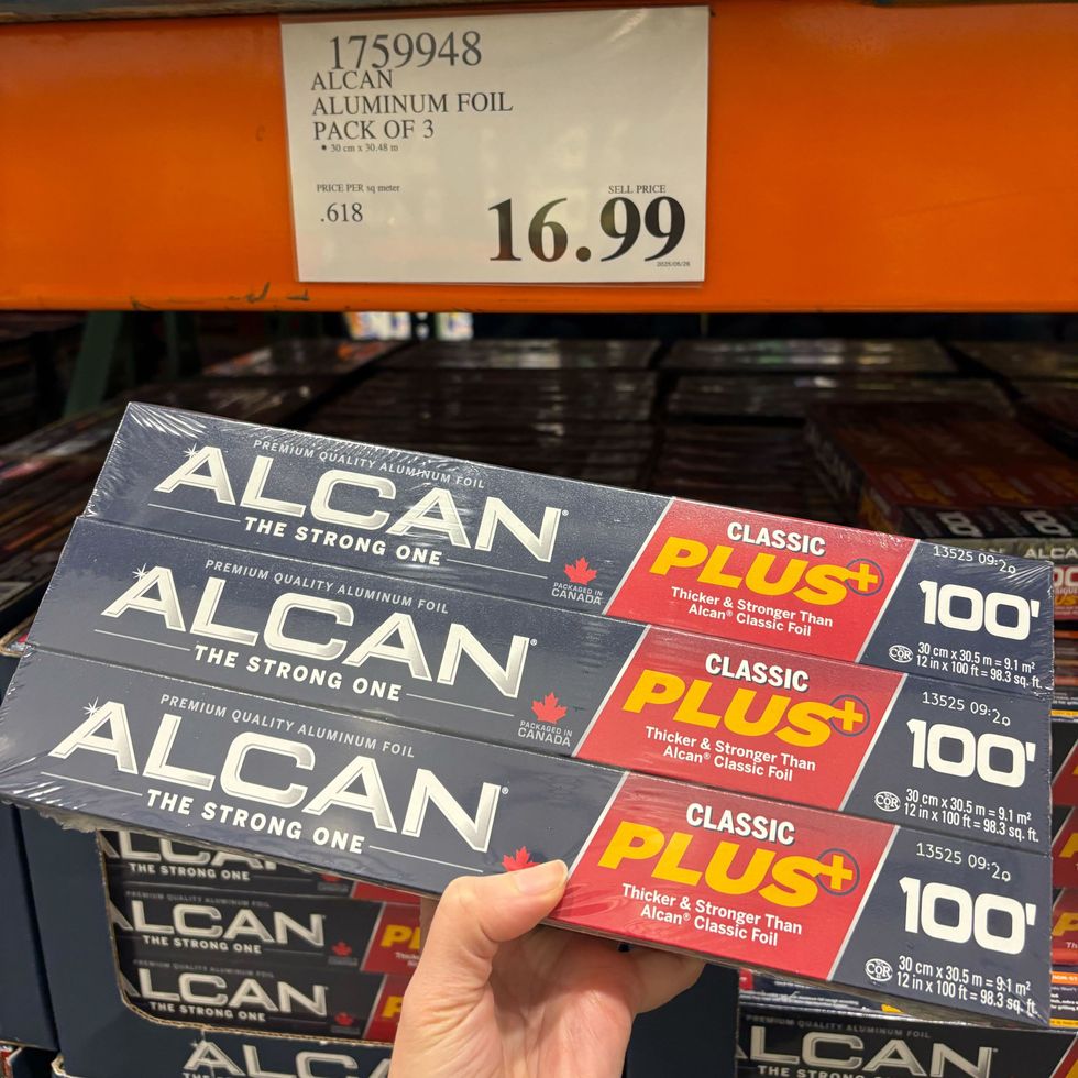 person holding pack of Alcan aluminum foil at costco