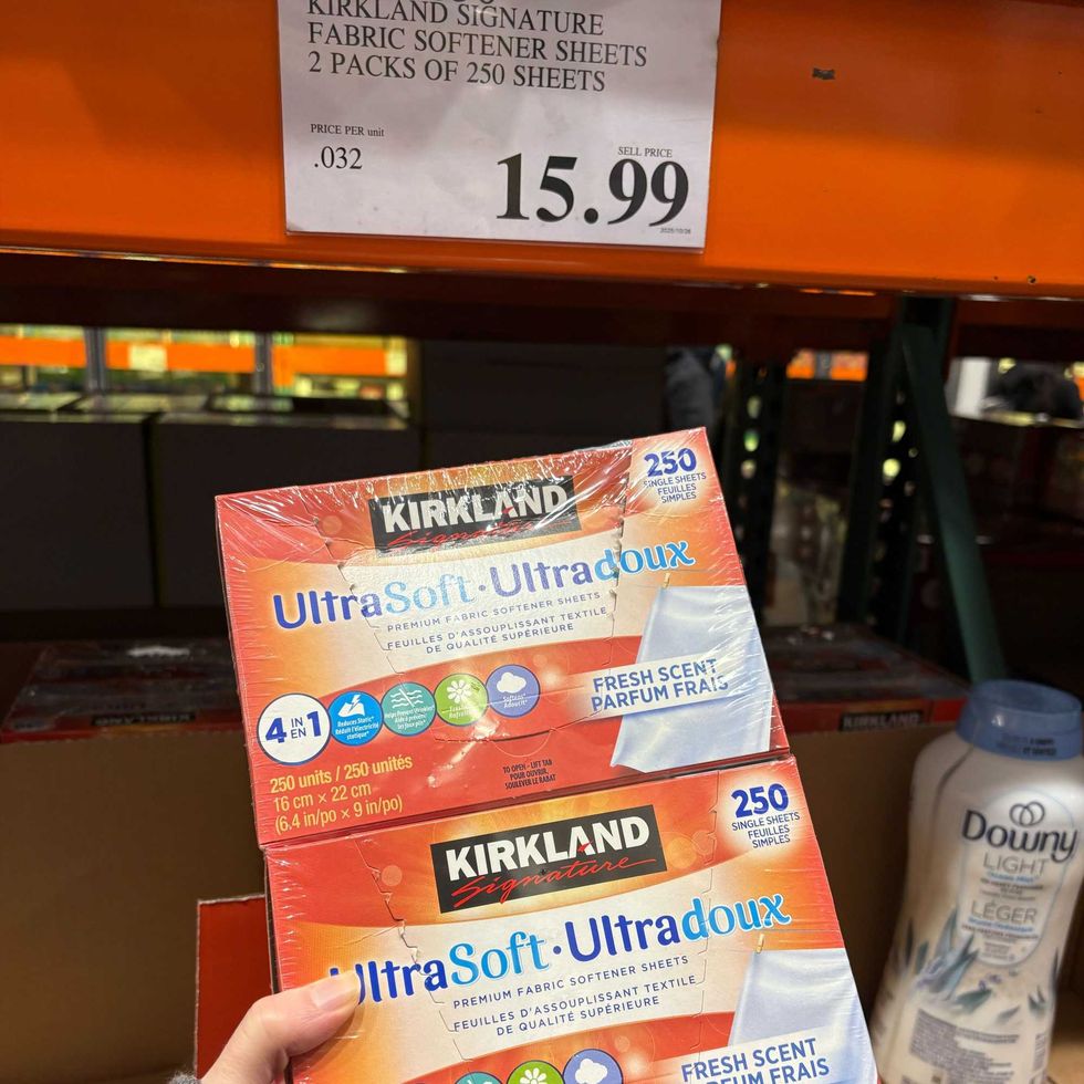 person holding pack of Kirkland Signature fabric softener dryer sheets